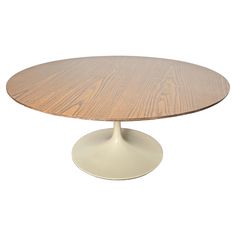 an oval wooden table with white base