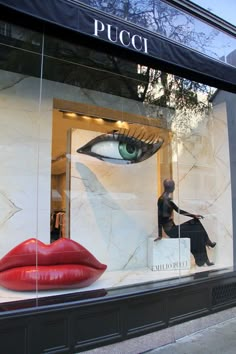 a window display with red lipstick and an eye