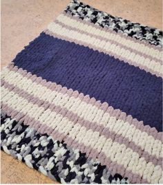 a knitted blanket is laying on the floor