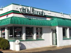 the exterior of a restaurant called old ritzy's with green and white awnings