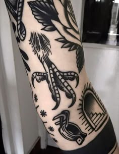 a person with a tattoo on their arm that has an eagle and other symbols around it