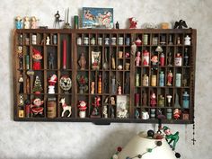 a shelf filled with lots of different types of christmas decorations on top of a wall