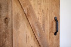 a wooden door with a black handle on it