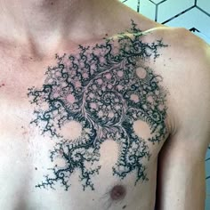 a man's chest with an intricate design on it