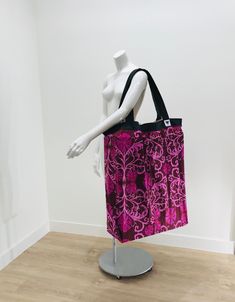 a mannequin's torso with a pink and purple bag on top of it