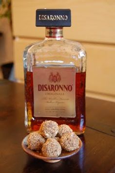 a bottle of disarrono and some cookies on a plate