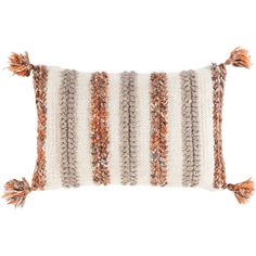 an orange and white striped pillow with tassels on the front, sitting against a white background