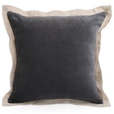 a black and beige pillow with two contrasting sides on a white background, the front is made out of linen