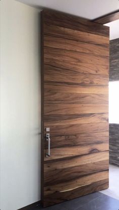 a modern wooden door in an empty room