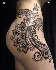 a woman's stomach with an intricate tattoo design on the side and bottom part