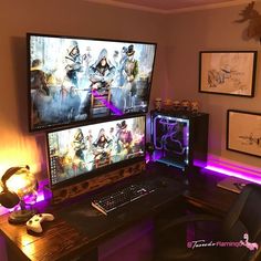 two computer monitors sitting on top of a desk