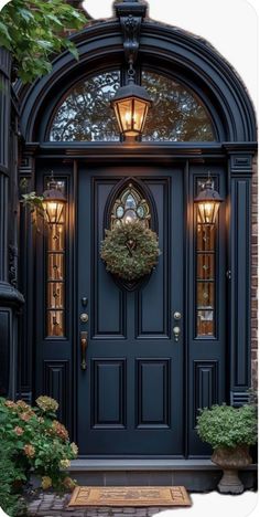 a blue front door with a wreath on the top and two lights above it that are lit up