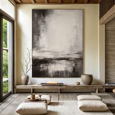 a large painting hanging on the wall in a living room