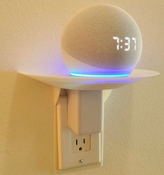 an alarm clock mounted to the side of a wall with a light on it's side