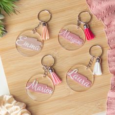 four personalized keychains with tassels on them