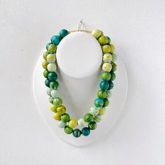 this 2-in-1 piece is a versatile strand of 50 colorful hand-painted beads. wear it as one, simple strand or double it up for a different look! necklace measures roughly 35” in length with a 17" drop wood beads measure 5/8” strung on 14k gold-over-brass with a 14k gold-filled 'ball & socket' clasp. Please Note: * your necklace may vary slightly from the one shown - while the colors and process are the same, each piece is hand-painted and the patterns random so therefore truly unique. * my hand-pa Multicolor Necklaces With Wooden Beads, Artisan Multicolor Wooden Beads Necklace, Artisan Yellow Necklace With Wooden Beads, Multicolor Wooden Oval Beads Necklace, Unique Multi-strand Wooden Beaded Necklaces, Painted Beads, Hand Painted Beads, Lampwork Necklace, The One Show