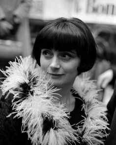 black and white photograph of a woman wearing a fur collar