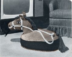 the horse is wearing a bridle and sitting on top of a cushion in front of a tv