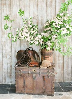 an old trunk with flowers and shoes on it