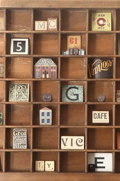 a wooden shelf filled with lots of different types of magnets