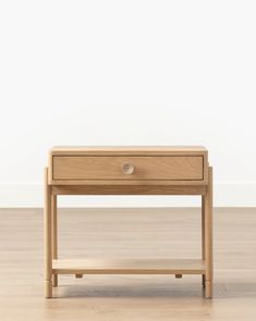 a small wooden table with two drawers on one side and an open drawer on the other