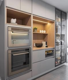 a modern kitchen with stainless steel appliances and cabinets