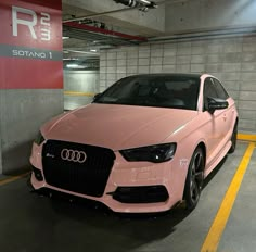 a pink car parked in a parking garage