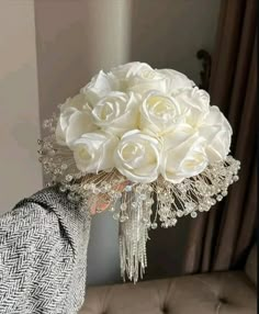 a bouquet of white roses in front of a mirror