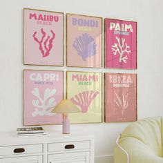 four pink and yellow posters hang on the wall above a white dresser in a living room