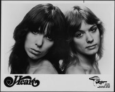 two women with long hair are posing for the camera