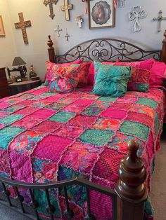 a bed with a colorful quilt on top of it