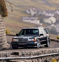 a black mercedes parked on the side of a road