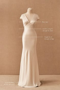 the back of a wedding dress with its measurements and details on display in front of a beige background