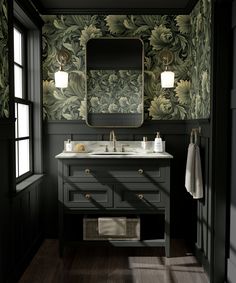 an elegant bathroom with green wallpaper and dark wood flooring