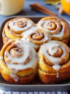 cinnamon rolls with icing in a baking pan