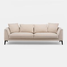 a beige couch with four pillows on the back and one arm folded out to show it's shape