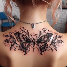 the back of a woman's neck with a butterfly tattoo design on it,