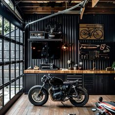 a motorcycle parked inside of a garage next to a wall mounted bike rack and window