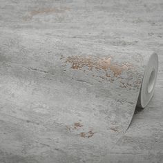 a roll of tape sitting on top of a concrete floor