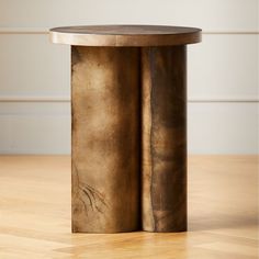 a table that has some kind of metal object on it's side, sitting on a wooden floor