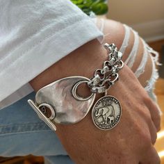 Awesome chunky bracelet decorated with antique toggle clasp and elephant charm.  Made of a mixt of bright silver rolo and cable chain with antique silver clasp and charm, you'll be charmed by the stylish look of this bracelet. The chains are innoriginal and platinum silver plated stainless steel. The toggle clasp and elephant charm are in antique silver Zamak (real 925 antique silver plated pewter).  On picture, 6.5 inches wrist showing the 8 inches bracelet. Add approximately 1.25 - 1.5 inch (37mm) to your wrist size. You will receive this beautiful bracelet in a box decorated with bow. Thank you for visiting! Luxury Silver Bracelet Charms, Luxury Silver Beaded Bracelets With Sterling Silver Clasp, Luxury Silver Round Charm Bracelet, Classic Luxury Sterling Silver Bracelet As Gift, Luxury Elegant Jewelry Stamped 925, Luxury Silver Jewelry With Charms, Luxury Elegant Silver Charm Bracelet, Luxury Bohemian Sterling Silver Stamped Bracelet, Luxury Silver Bohemian Beaded Bracelets