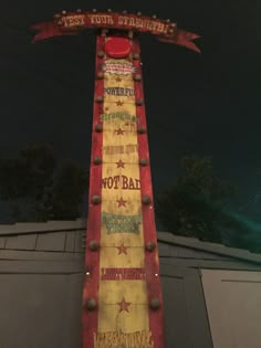 a sign that is sitting on the side of a building with stars and stripes painted on it