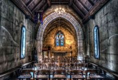 the interior of an old church with stained glass windows