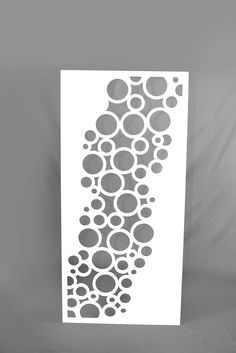 a white poster with circles on it in front of a gray background and the bottom half is black