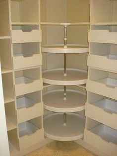 an empty pantry with white shelves and no doors