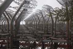 many metal structures with trees in the foreground