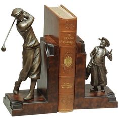 a bookend with two books and a statue of a man holding a golf club