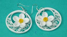 the earrings are made out of plastic and have white flowers on each earwires