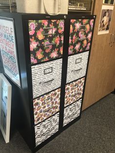 an office cubicle with several drawers and pictures on the wall next to each other