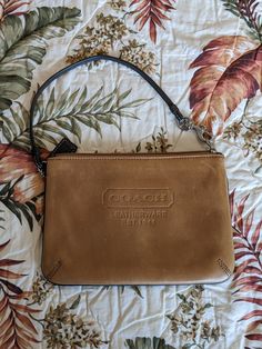 "This vintage Coach brown Leatherware wristlet is in very good condition. It is lined with solid light brown fabric with the Coach emblem. Black strap and silver tone hardware. It measures approximately 6.5\" by 4\"." Sterling Silver Flatware, Bee Pendant, Brown Fabric, Vintage Coach, Design Silver, Gold Plated Sterling Silver, Wristlets, Purses And Handbags, Light Brown